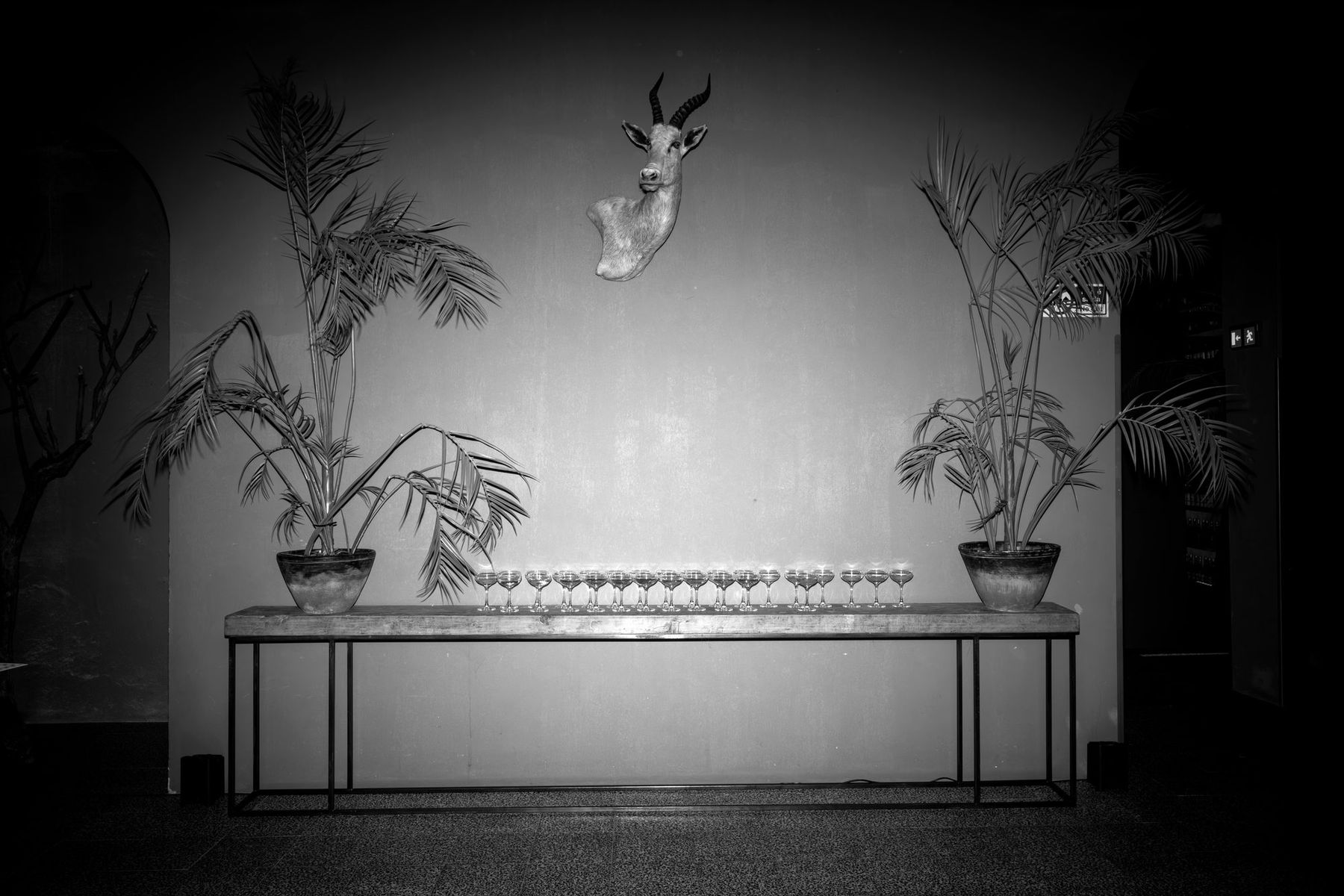 A welcome table set with glassware in a Lisbon venue, before guests arrive